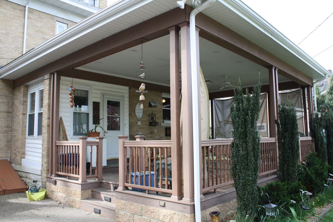 Covered porch with wood railings