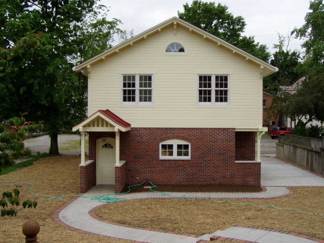 Newly built two-story garage building with brick lower level